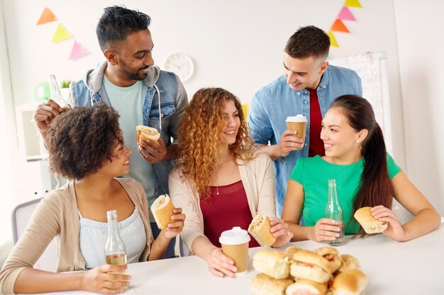 corporate celebration people concept happy friends team eating sandwiches with coffee nonalcoholic drinks office party 380164 192706 2